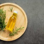 can-rosemary-oil-regrow-hair-rosemary-oil-bottle-with-rosemary-plants